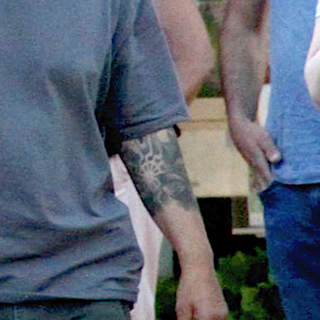 Zugeschnittenes Foto von Matthias Körper. Auf dem linken Arm ist ein Tattoo zu erkennen, das der schwarzen Sonne ähnelt.