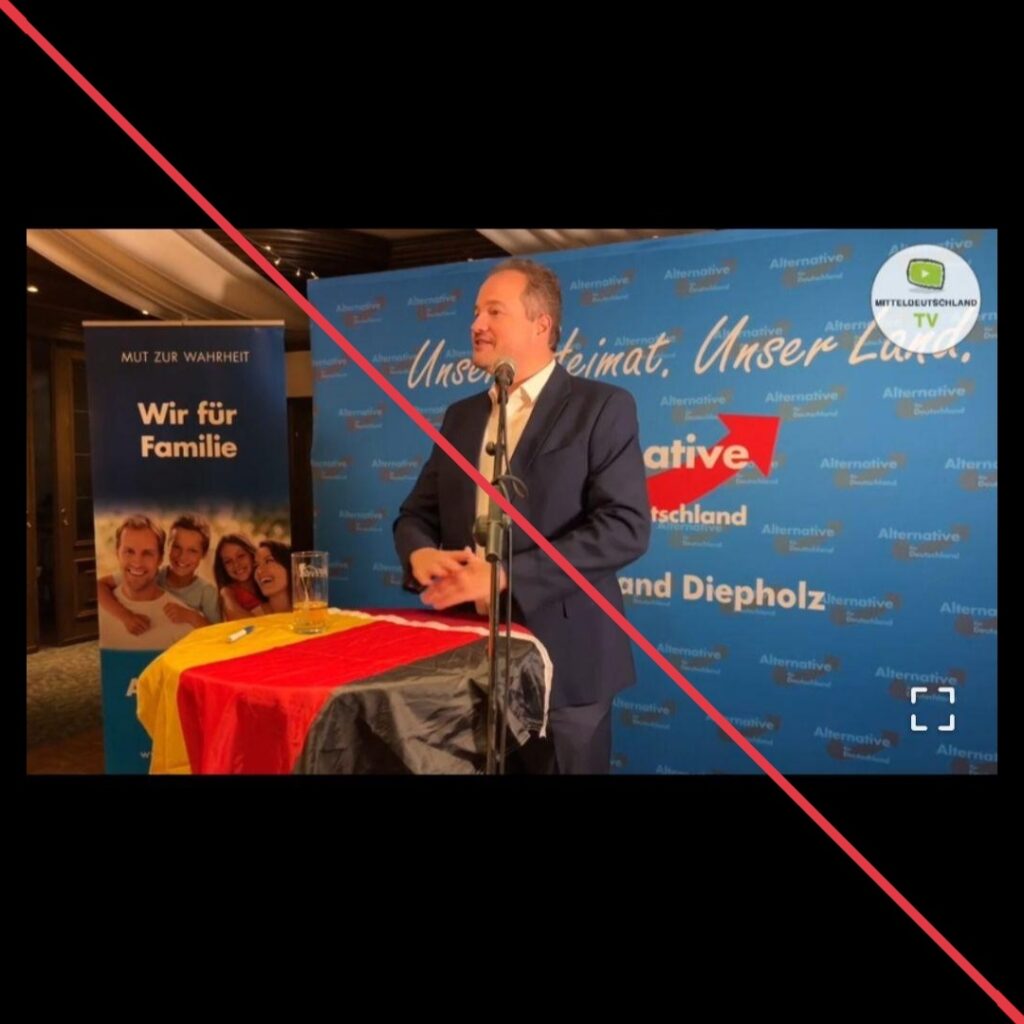 Screenshot aus einem Telegram-Video, Martin Sichert vor einer AfD-Wand am Rednerpult.